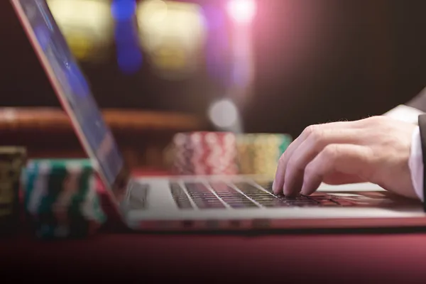 A professional dealer in a tuxedo greeting players at the roulette table, symbolizing the authentic live casino feel at BH999.