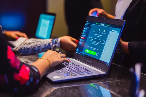 A confident dealer surrounded by casino chips inviting players to access their BH999 account, reflecting quick and easy login options.